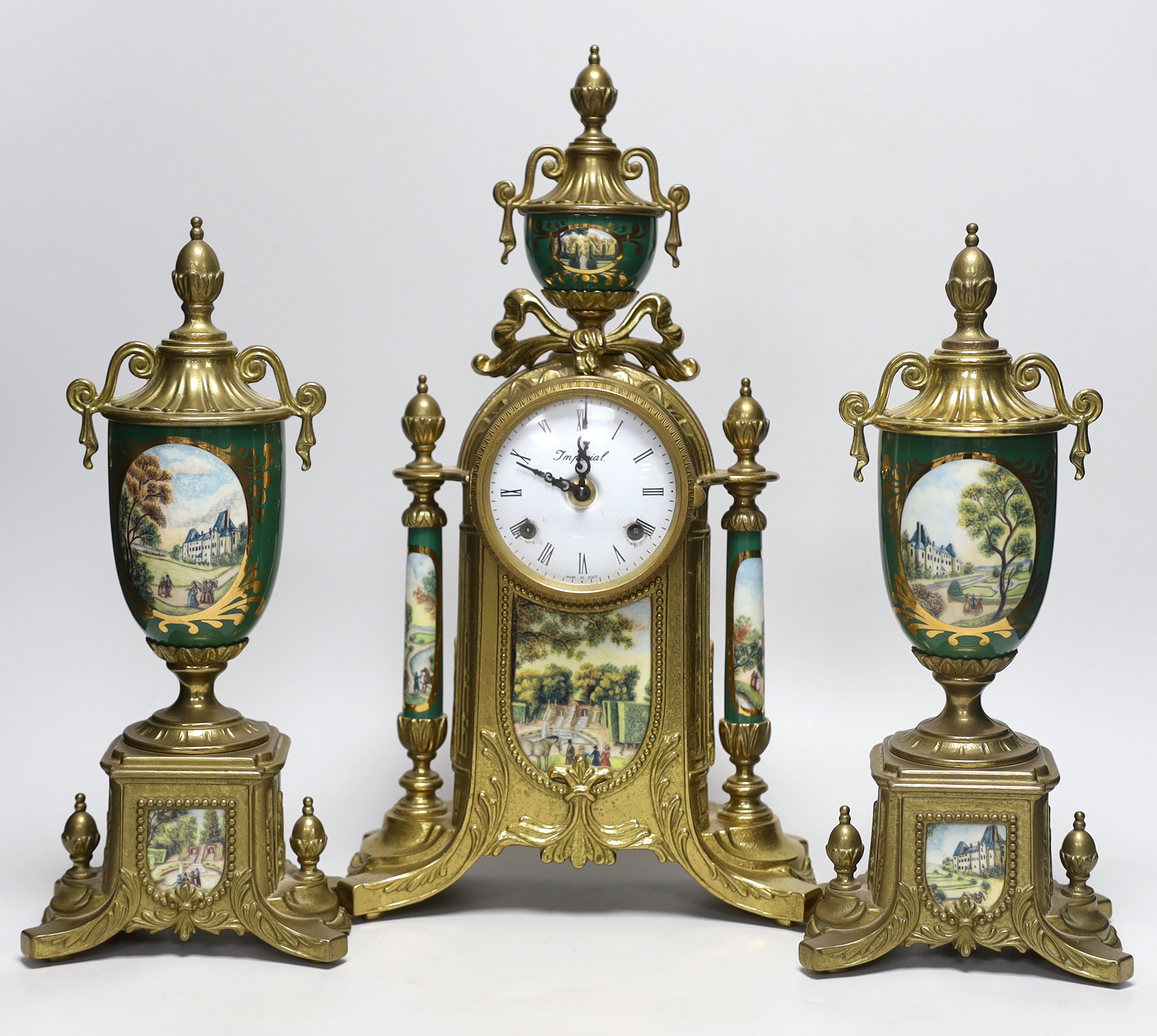 A three piece brass and porcelain clock garniture, clock 43cm high